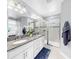Luxurious bathroom with double vanity, granite counters, and glass-enclosed shower at 3708 Wayfarer Way, Palmetto, FL 34221