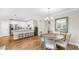 Bright open concept dining room with hardwood floors, white cabinets, and stainless appliances at 3708 Wayfarer Way, Palmetto, FL 34221