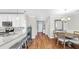 Bright hallway connecting the kitchen, dining area, and entryway with hardwood floors at 3708 Wayfarer Way, Palmetto, FL 34221