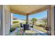 Screened lanai with outdoor seating and views of the pond and landscaped backyard at 3708 Wayfarer Way, Palmetto, FL 34221