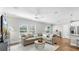 Spacious living room with a sectional sofa, modern round coffee table, and bright natural light at 3708 Wayfarer Way, Palmetto, FL 34221