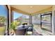 Enclosed patio with table and chairs overlooking the fenced yard, offering a private outdoor space at 3708 Wayfarer Way, Palmetto, FL 34221