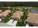 Aerial view showcasing a home with a tile roof, surrounded by lush landscaping and a golf course at 379 Fairway Isles Ln, Bradenton, FL 34212