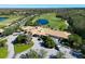 Aerial view of golf community clubhouse with pond and lush landscaping and golf course at 379 Fairway Isles Ln, Bradenton, FL 34212