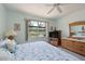 Cozy bedroom with a serene view and wicker furnishings at 379 Fairway Isles Ln, Bradenton, FL 34212