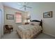 Cozy bedroom with a floral patterned comforter set and a ceiling fan at 379 Fairway Isles Ln, Bradenton, FL 34212
