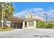 Clubhouse exterior with porte cochere, stone accents, tile roof, and manicured landscaping at 379 Fairway Isles Ln, Bradenton, FL 34212