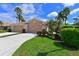 Charming home with a well-manicured lawn, lush landscaping, and a welcoming double garage at 379 Fairway Isles Ln, Bradenton, FL 34212