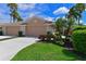 Charming home with a well-manicured lawn, lush landscaping, and a welcoming double garage at 379 Fairway Isles Ln, Bradenton, FL 34212