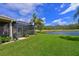 Exterior home view featuring a screened in lanai, golf course and lush backyard at 379 Fairway Isles Ln, Bradenton, FL 34212