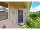Charming front door with a screen, surrounded by lush landscaping and inviting curb appeal at 379 Fairway Isles Ln, Bradenton, FL 34212