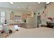 Charming kitchen featuring unique pink cabinetry and a bright, open layout at 379 Fairway Isles Ln, Bradenton, FL 34212
