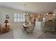 Open-concept kitchen with breakfast bar, adjacent to dining area and natural light at 379 Fairway Isles Ln, Bradenton, FL 34212