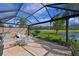 Spacious screened lanai with comfortable seating overlooking a serene pond and golf course at 379 Fairway Isles Ln, Bradenton, FL 34212
