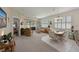 Spacious living room flowing into dining area, featuring bright windows and stylish furnishings at 379 Fairway Isles Ln, Bradenton, FL 34212