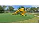Community playground with slide, swing set and bright yellow features, located near lake at 379 Fairway Isles Ln, Bradenton, FL 34212