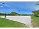 Sand volleyball court with blue net and a lake in the background at 379 Fairway Isles Ln, Bradenton, FL 34212