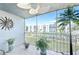 Screened balcony with furniture and palm tree, showcasing a clear view of the building and surrounding landscape at 3980 Ironwood Cir # 206, Bradenton, FL 34209