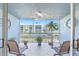 Inviting screened balcony featuring outdoor furniture and a view of the pool, palm trees and surrounding buildings at 3980 Ironwood Cir # 206, Bradenton, FL 34209
