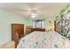 Comfortable bedroom with a decorative wrought iron bed frame, ceiling fan, and two dressers at 3980 Ironwood Cir # 206, Bradenton, FL 34209