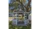 Charming white gazebo is nestled amidst lush greenery offering a serene retreat at 3980 Ironwood Cir # 206, Bradenton, FL 34209