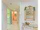 Inviting hallway with coastal decor, leading to the laundry room and a stylish bathroom at 3980 Ironwood Cir # 206, Bradenton, FL 34209