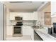 Updated kitchen with stainless steel appliances, sleek countertops, and modern fixtures, ready for cooking at 3980 Ironwood Cir # 206, Bradenton, FL 34209