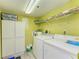 Efficient laundry room with washer, dryer, storage cabinets and a utility sink for added convenience at 3980 Ironwood Cir # 206, Bradenton, FL 34209