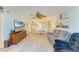 Inviting living room with beachy decor, light blue walls, and an open layout to the dining space at 3980 Ironwood Cir # 206, Bradenton, FL 34209