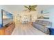 Bright and airy living room with wood-look floors, coastal decor, and views of the dining area at 3980 Ironwood Cir # 206, Bradenton, FL 34209