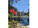 Scenic pond with fountain offers a tranquil view of the condos from lush landscaping at 3980 Ironwood Cir # 206, Bradenton, FL 34209