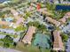 Scenic aerial view of the condo community featuring community pool, tennis courts, mature trees, and well-maintained landscaping at 4001 Crockers Lake Blvd # 16, Sarasota, FL 34238