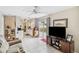 Open living space with white tiled flooring, ceiling fan, and sliding glass doors to the outdoor pool area at 4062 Palau Dr, Sarasota, FL 34241