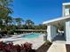 Relaxing community pool featuring lounge chairs, a covered seating area and lush landscaping for serene outdoor living at 4091 Via Sienna Cir, Sarasota, FL 34243