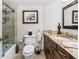 Clean bathroom featuring a tiled shower, toilet, and granite countertop sink at 435 S Gulfstream Ave # 1103, Sarasota, FL 34236