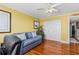 Bright room features a sofa with decorative pillows, ceiling fan, and closet with mirrored doors at 435 S Gulfstream Ave # 1103, Sarasota, FL 34236