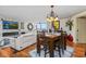 Dining room with wood floors, chandelier, and views of living room with fireplace and water view at 435 S Gulfstream Ave # 1103, Sarasota, FL 34236
