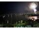 Night water view with fireworks in the distance over the water and a cityscape at 435 S Gulfstream Ave # 1103, Sarasota, FL 34236