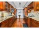 Well-maintained kitchen with wood cabinets, stone countertops, and stainless appliances at 435 S Gulfstream Ave # 1103, Sarasota, FL 34236