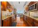 Gourmet kitchen with wood cabinets, granite counters, stainless steel appliances, and a view of the living room at 435 S Gulfstream Ave # 1103, Sarasota, FL 34236