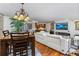 Comfortable living area with a white leather sofa, dining table, and a view of the kitchen at 435 S Gulfstream Ave # 1103, Sarasota, FL 34236