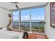 Bright living room showcasing floor-to-ceiling windows with beautiful water views and a mermaid statue at 435 S Gulfstream Ave # 1103, Sarasota, FL 34236