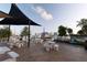 Outdoor seating area with picnic tables overlooking a marina and cityscape on a sunny day at 435 S Gulfstream Ave # 1103, Sarasota, FL 34236
