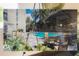 Beautiful community pool featuring patio seating surrounded by palm trees on a sunny day at 435 S Gulfstream Ave # 1103, Sarasota, FL 34236