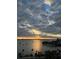 Serene view of the water at sunset, showcasing boats, palm trees, and vibrant colors at 435 S Gulfstream Ave # 1103, Sarasota, FL 34236