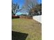 Large backyard enclosed by a mix of wood and white vinyl fencing for privacy and security at 4511 Ardale St, Sarasota, FL 34232