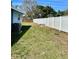 Fenced backyard with ample room for activities and a modern air conditioning unit at 4511 Ardale St, Sarasota, FL 34232