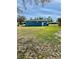 Large backyard behind a bright blue single story home at 4511 Ardale St, Sarasota, FL 34232