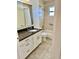 Bathroom featuring granite countertops and a shower with tile walls at 4511 Ardale St, Sarasota, FL 34232
