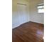 A clean bedroom with hardwood floors, a large closet, and a window for natural light at 4511 Ardale St, Sarasota, FL 34232